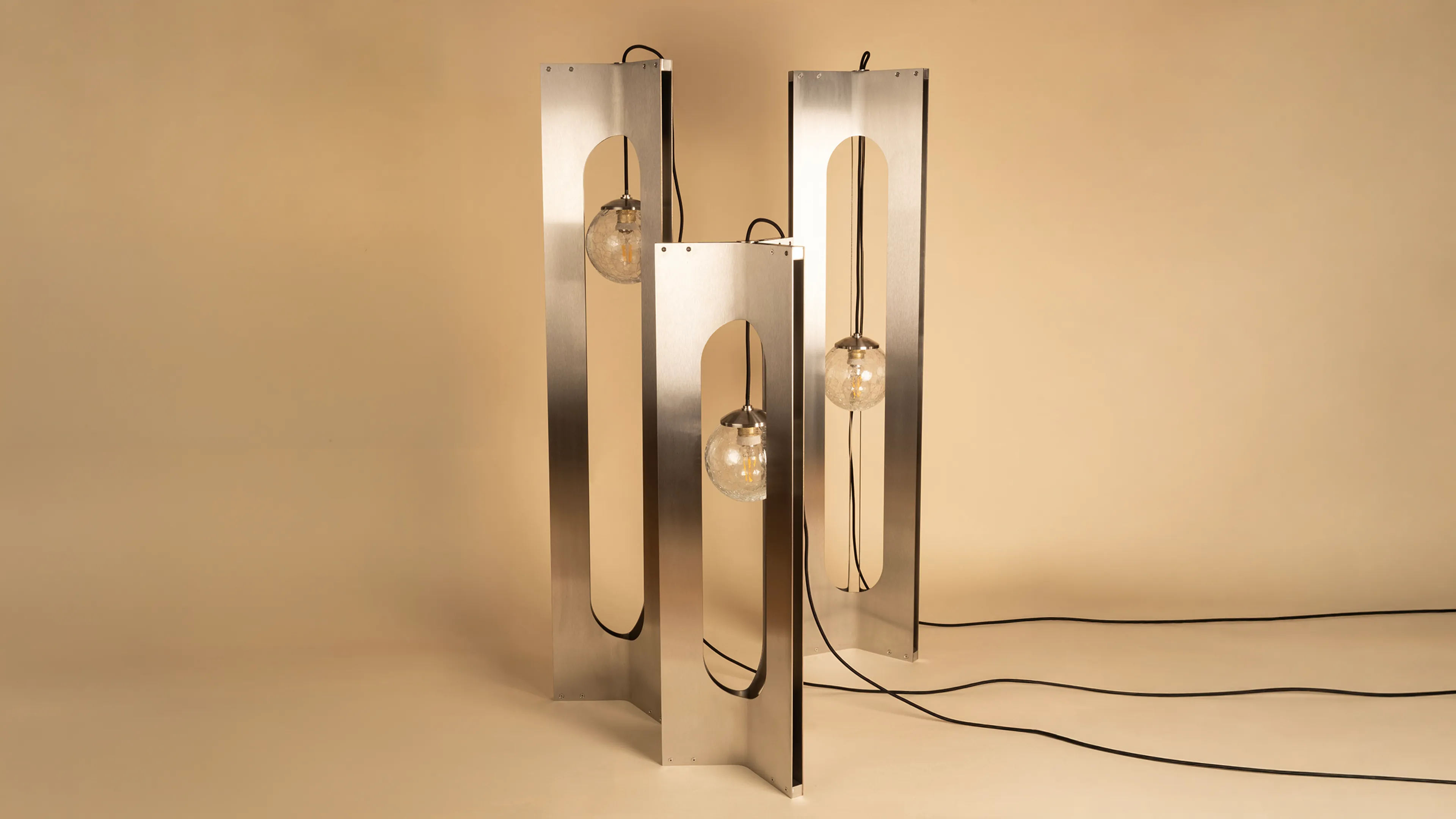 Three Crackdown floor lamps in satin stainless steel with crackle glass globes